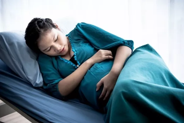 Pregnant woman resting on the hospital bed