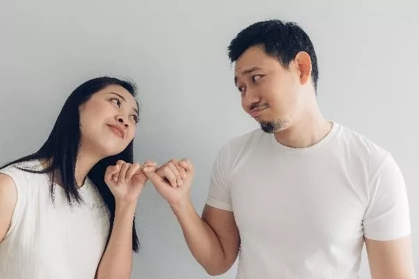 husband and wife hooking their little fingers together